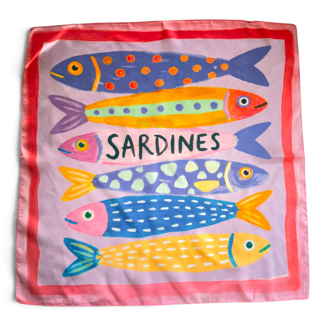 Pink silky square scarf with colourful illustrated sardines in blue, yellow, orange and mint, featuring a lilac background and coral-pink border.